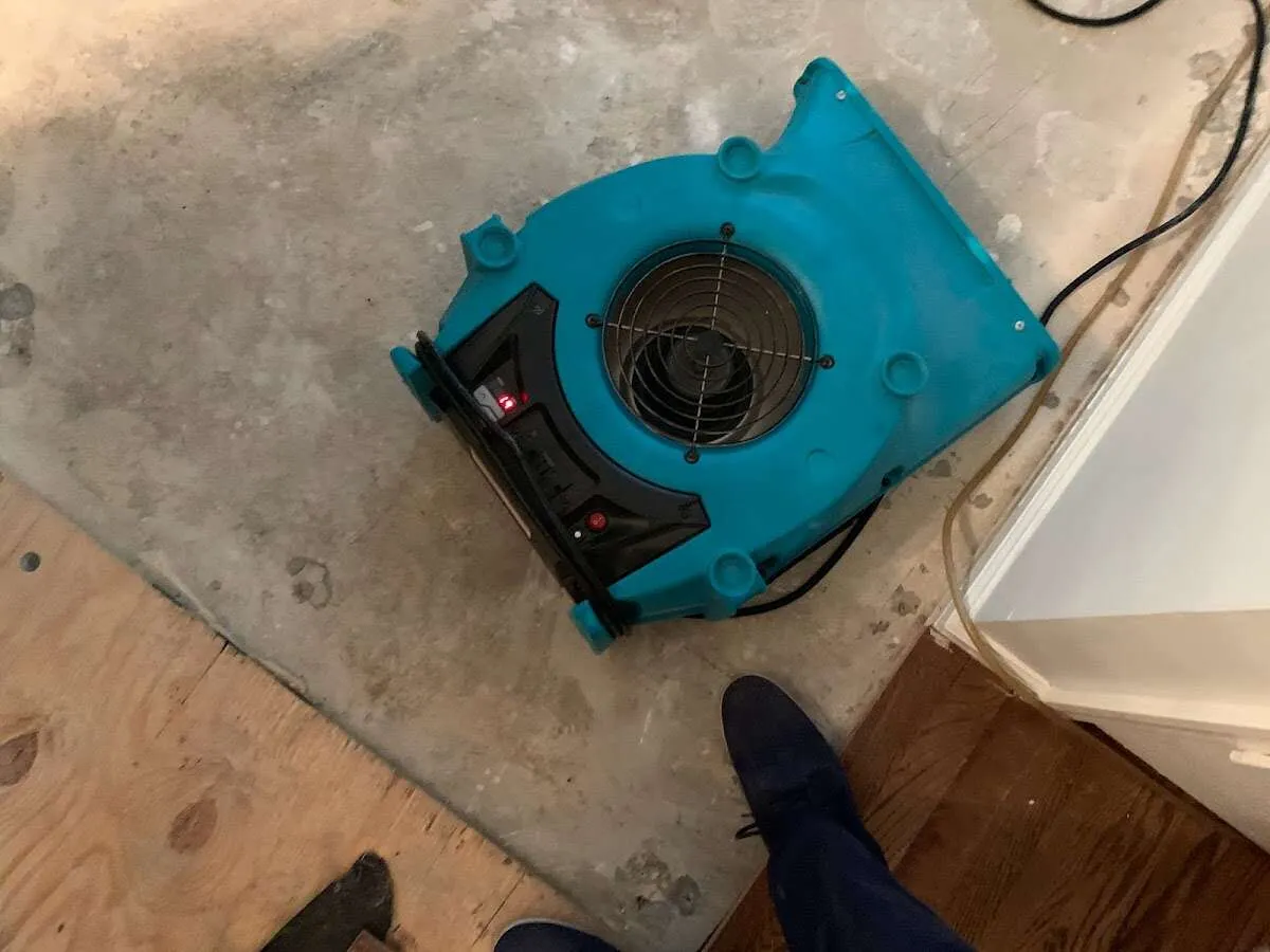 Air mover drying subfloor during Commercial Water Damage Restoration in Crescent City